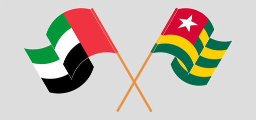 Crossed and waving flags of the United Arab Emirates and Togo