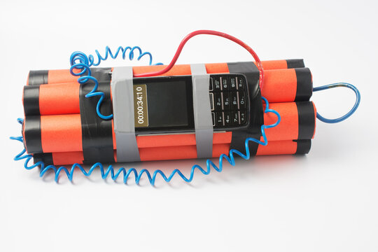 ready assembled bomb with a clockwork from an old smartphone rewound with electrical tape on a white background. terrorism concept.