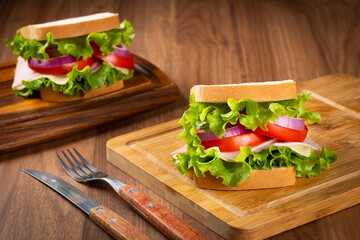 Natural sandwich. Sandwich with cheese, ham, lettuce, tomato and red onion.