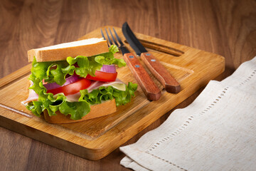 Natural sandwich. Sandwich with cheese, ham, lettuce, tomato and red onion.