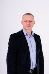Man wearing a blue shirt, black pants and a blue jacket on a white background