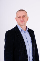 Man wearing a blue shirt, black pants and a blue jacket on a white background