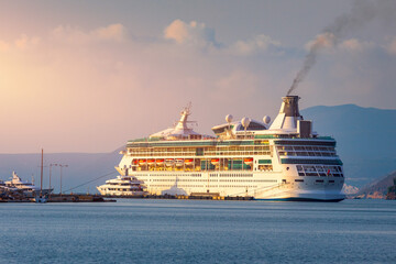Cruise ship at harbor. Beautiful large white ship at sunset. Colorful landscape with cruiser in...