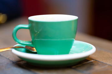 decorated glass of Coffee Piccolo Latte on a white table in a Sydney Cafe NSW Australia