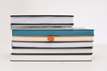 A stack of paper books or diaries for writing on a white background