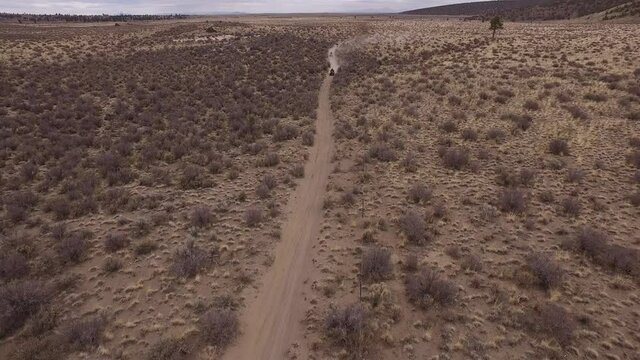 2 ATVs and 2 dirt bikes riding desert trails, Bend, Oregon