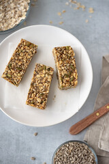 A plate with three home made granola bars for a energy-filled breakfast.