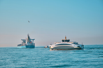 Fototapeta na wymiar Turkey istanbul 03.03.2021. Pedestrian ferry and cargo transportation ship in bosporus early in the morning in istabul in golden horn.