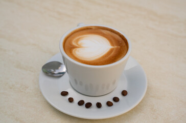 Background image of cappuccino in a cup with coffee beans