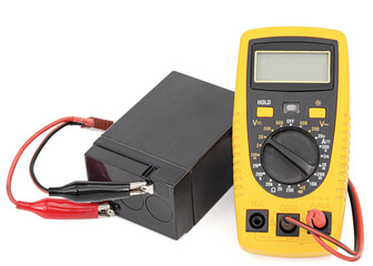 Testing an acid rechargeable battery with a measuring instrument isolated on white background