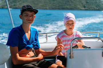 beautiful girl drive the speed boat in Greece. Little girl on a private yacht in the sea....