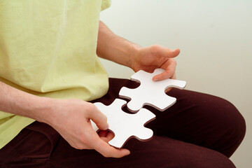 person holding and connecting jigsaw pizzles, solving the problem