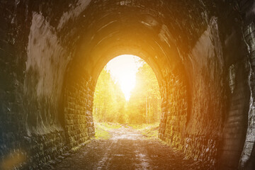 Exit from the tunnel to the flare of the sun. Light at the end of the old tunnel.