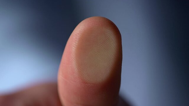 Marco video of fingerprint on glass surface indoors.Man thumbprint on windowpane