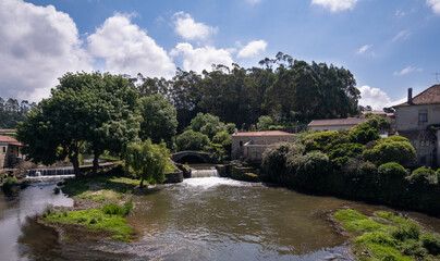 Fototapeta na wymiar Rural landscape in Portugal with river. River Este in Touguinho, Vila do Conde, Portugal with historic stone bridge