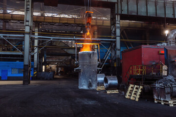 Iron casting and the foundry. Overhead crane with ladle with molten metal at metallurgical factory