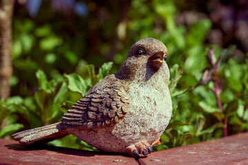 ceramic garden figure of a little bird, inscription welcome to my garden.