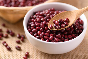 Azuki beans or red mung beans in a wooden spoon and bowl, Food ingredients in many Chinese dishes and filling in Japanese sweet