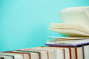 Composition with vintage old hardback books, diary, fanned pages on wooden deck table