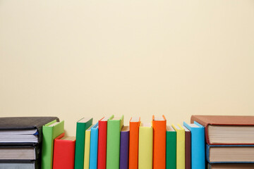 Composition with vintage old hardback books, diary, fanned pages on wooden deck table and colored background. Books stacking. Back to school. Copy Space. Education background.