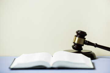  law book with a wooden judges gavel on table