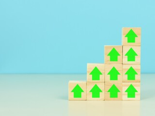 Business growth process concept. Wooden cubes with percentage and arrow icons stacking as stairs upward direction.