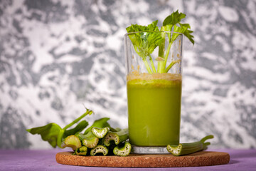 Healthy Celery diet for the treatment of incurable mysterious diseases. Fresh celery juice squeezed out on a juicer.drink, vegetable juice, studio shot