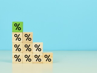 Wooden cubes with percentage icons stacking as stairs. Interest, financial and mortgage rates concept. 