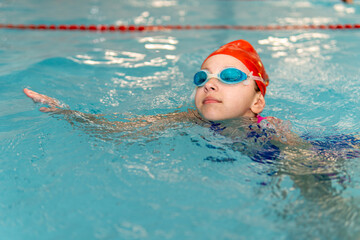 Girl swimming stroke closeup. open water competition among children. Sports and entertainment for children. Swimming competition. Healthy lifestyle from childhood.