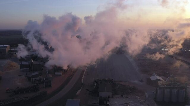 Estonia-November 25. 2019: Drone shote of the sawmill forest industry in Imavere Estonia where wood materials is made and the thick smoke coming from the pipe