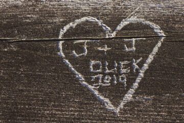 curved heart, love message on a tree trunk, vintage grain texture background