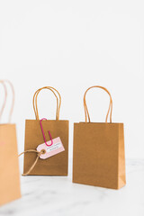 women-owned business tag on shopping bag surrounded by competitors' bags, supporting equality