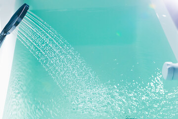 shower filling a bathtub with water stream