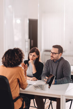 Couple Consulting With A Female Financial Manager At The Bank