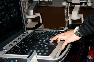 Male hand on an ultrasound machine