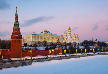 Scenic view of Moscow embankment near Moskva River overlooking medieval Kremlin at sunset in winter, Russia
