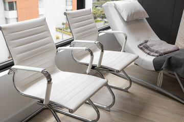 details of several white modern leather chairs, furniture in the office interior, style and glamor in the decoration