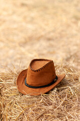 Leather Cowboy hat on straw background