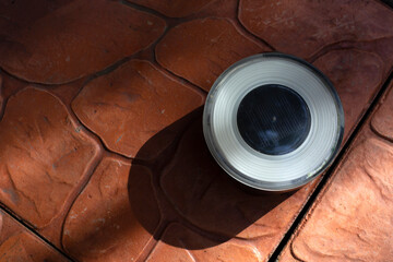 Outdoor solar led lamp on floor waiting for sunlight charging