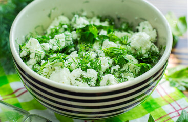 Fresh cottage cheese with spinach and herbs