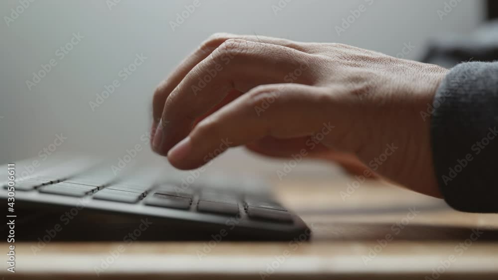 Aufkleber Close-up view of man typing on computer keyboard. Working from home