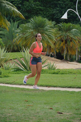 young girl running in the park. Exercise with sunny day, sports clothes.