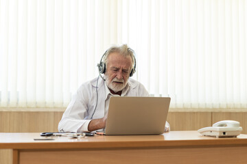 Senior old doctor wears headset. Remote online medical chat consultation, tele medicine distance...