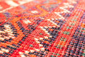 South Persian rug pattern, macro. Backside of carpet with multiple geometric line patterns. Selective focus with defocused and abstract front and back. Textile backdrop or background texture.