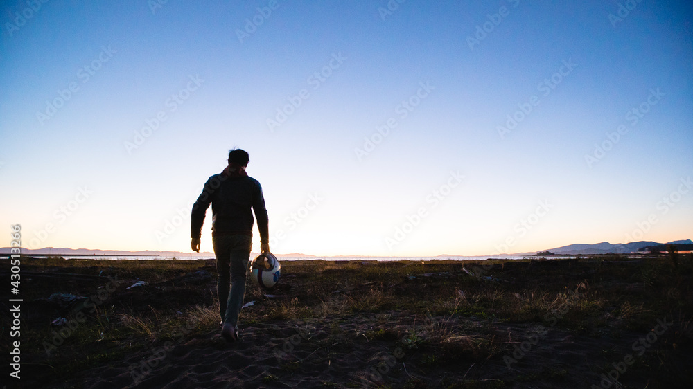 Wall mural Unknown Biker walks into horizon