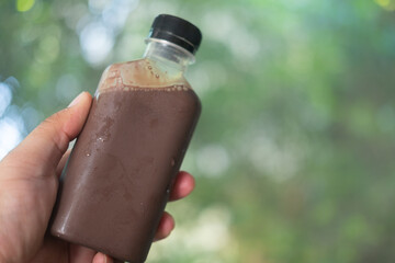 Cool Mocha coffee in plastic bottle in hand,