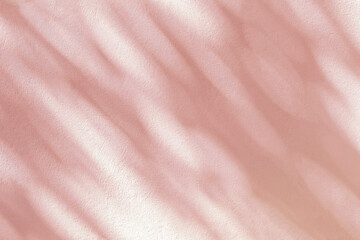 Fototapeta premium Abstract light shadow of leaves bokeh blurred background. Natural diagonal leaves tree branch pink shadows and sunlight dappled on white wall texture, shadow overlay effect