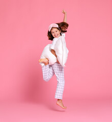 Optimistic girl with pillow jumping