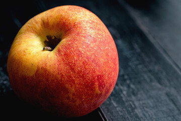 The envy apple on black wooden board after bring out of the refrigerator.