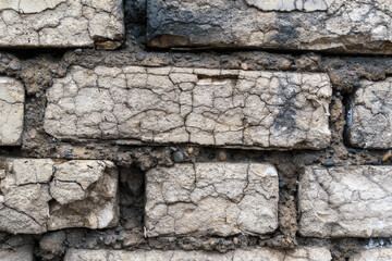 Brickwork wall. White bricks with chips and cracks. Ancient wall concept.